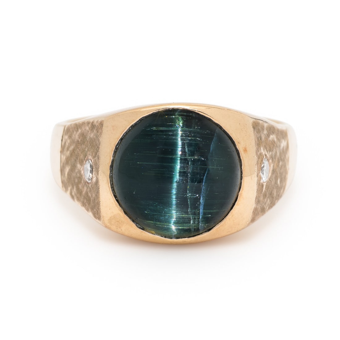 Cat's Eye Indicolite Tourmaline and Diamond Ring: Cat's Eye Indicolite Tourmaline and Diamond Ring Featuring a round cabochon cat's eye indicolite tourmaline weighing approximately 10.00 carats by formula and set with two transitional cut diamonds. M