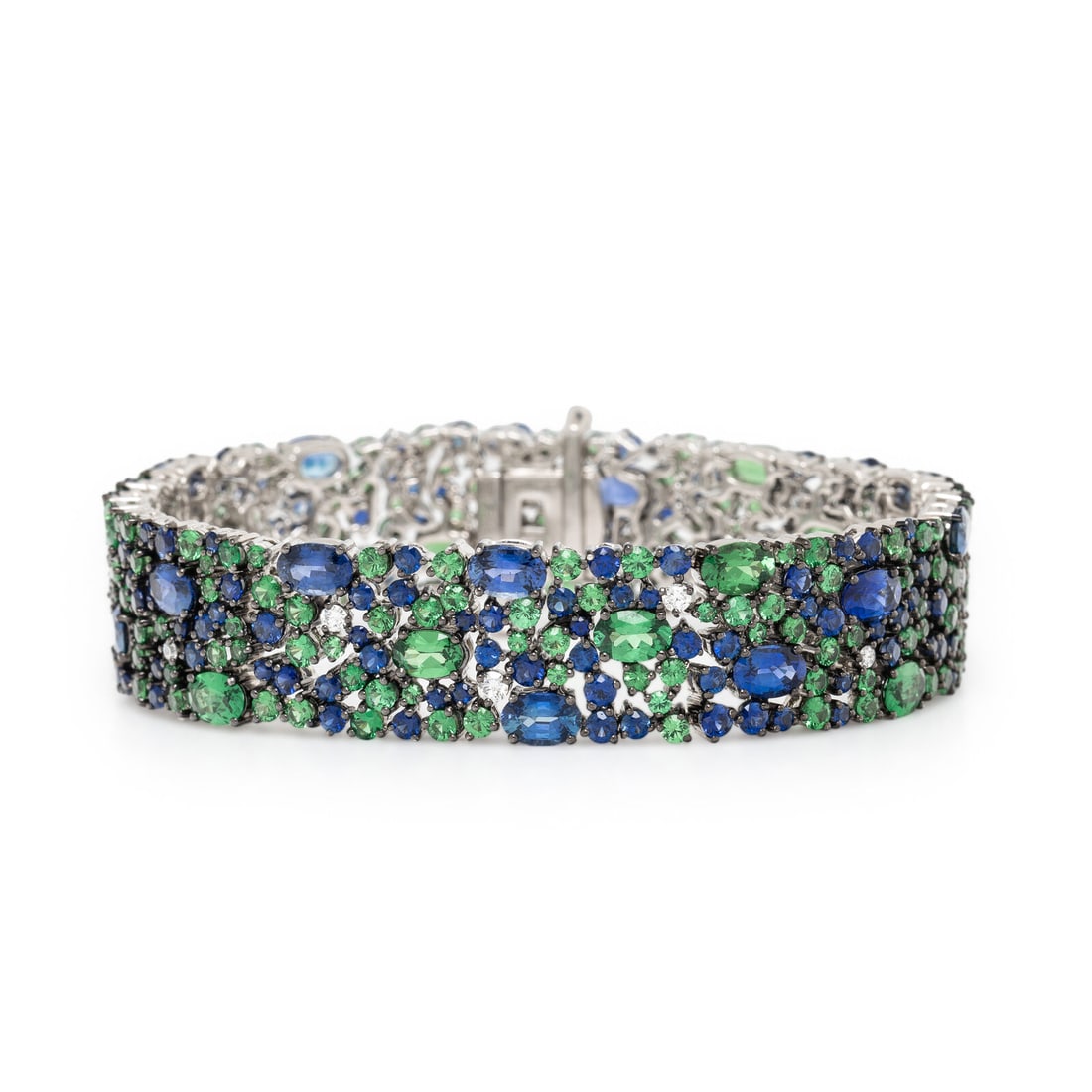Robert Procop, Sapphire, Tsavorite Garnet, Diamond, and White Gold 'American Glamour' Bracelet: Robert Procop, Sapphire, Tsavorite Garnet, Diamond, and White Gold 'American Glamour' Bracelet In an openwork design, set throughout with round and oval sapphires weighing approximately 14.78 carats t