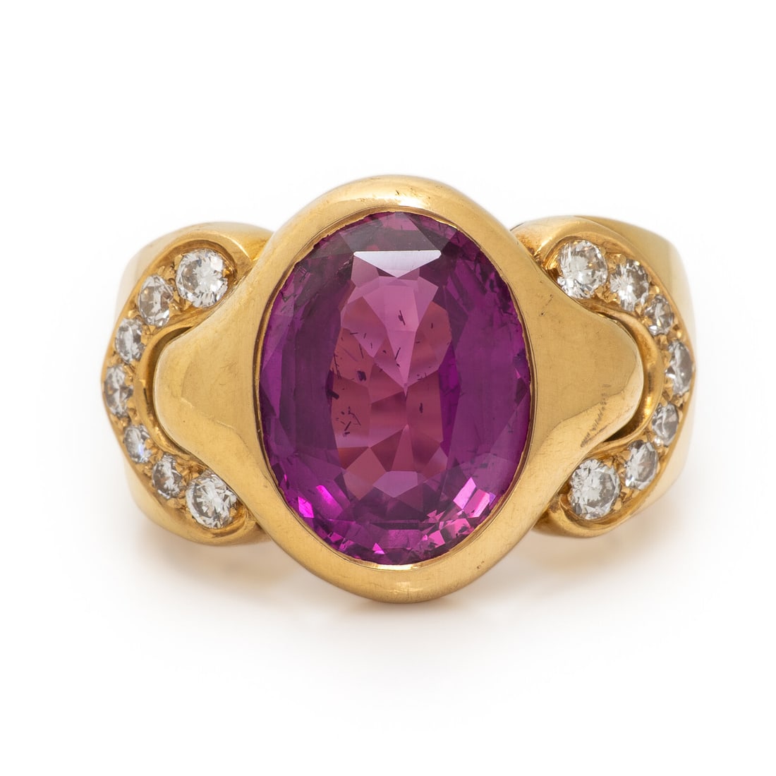 Bulgari, Ruby, Diamond, and Yellow Gold Ring: Bulgari, Ruby, Diamond, and Yellow Gold Ring Featuring an oval ruby weighing approximately 5.20 carats by formula, bezel set and framed by sculpted shoulders set with round brilliant cut diamonds weig