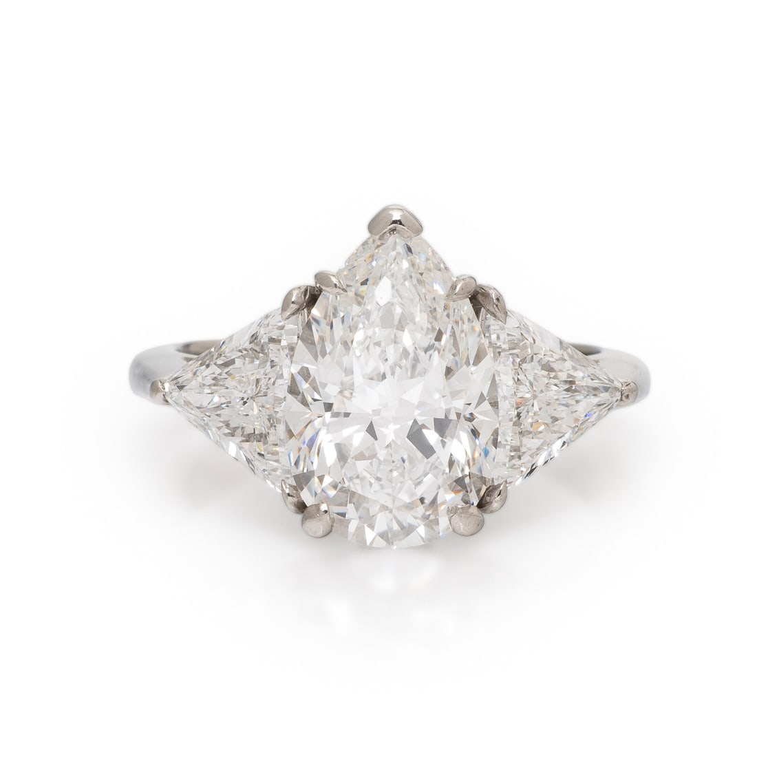 Tiffany & Co., Diamond and Platinum Ring: Tiffany & Co., Diamond and Platinum Ring Featuring a pear shape diamond weighing 4.04 carats, and flanked by two trillion cut diamonds weighing approximately 2.15 carats total. Mounted in platinum. Ri