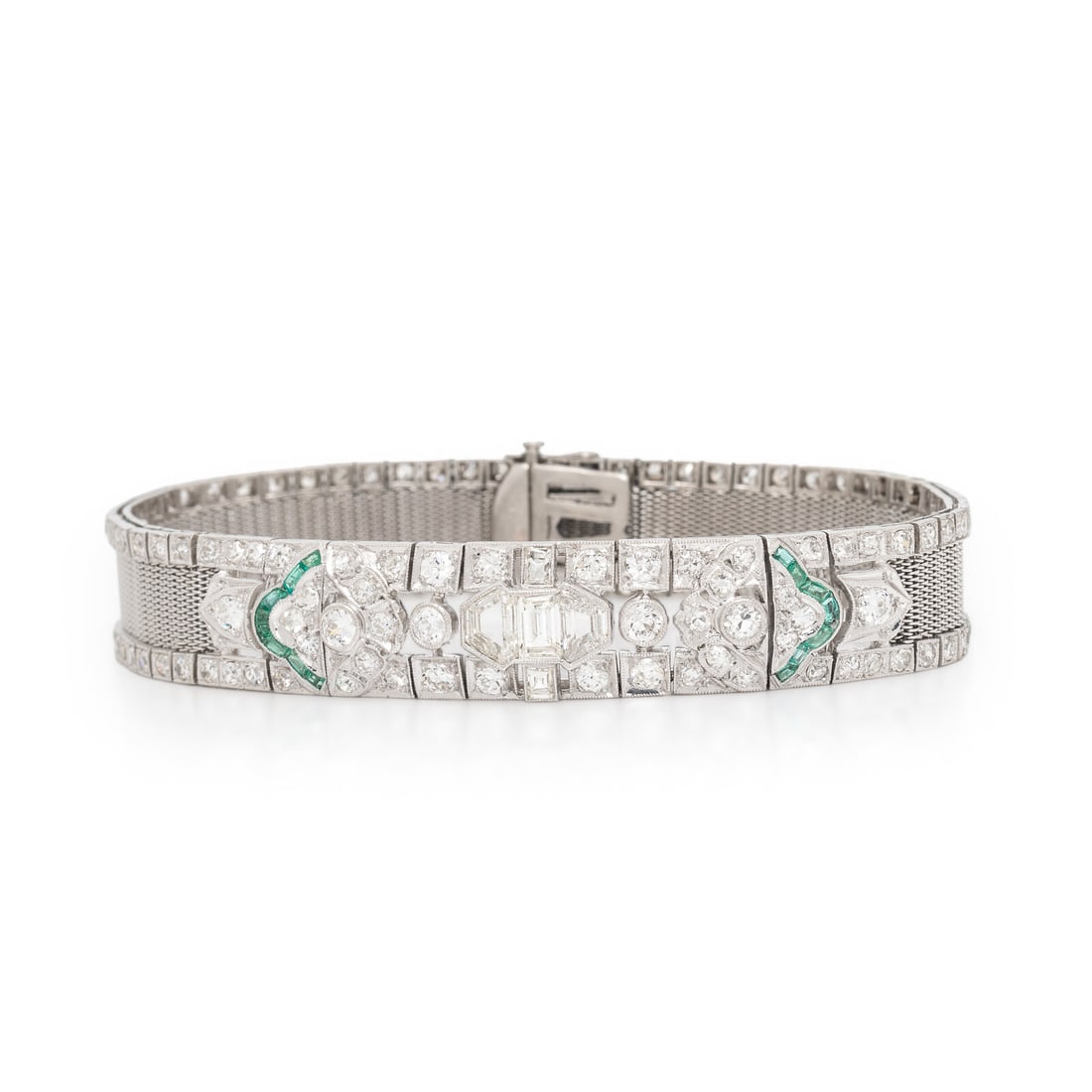 Art Deco, Diamond, Emerald, and Platinum Bracelet: Art Deco, Diamond, Emerald, and Platinum Bracelet Featuring calibré-cut emeralds and transitional, baguette, single, and shield cut diamonds weighing approximately 6.40 carats total. Mounted in p