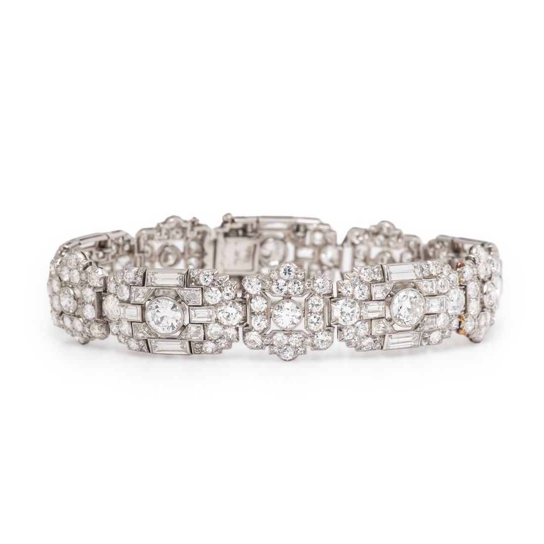 Art Deco, Diamond and Platinum Bracelet: Art Deco, Diamond and Platinum Bracelet Featuring round brilliant, trapezoidal, and baguette cut diamonds weighing approximately 22.00 - 24.00 carats total. Mounted in platinum. 7 3/8 inches long. Sta