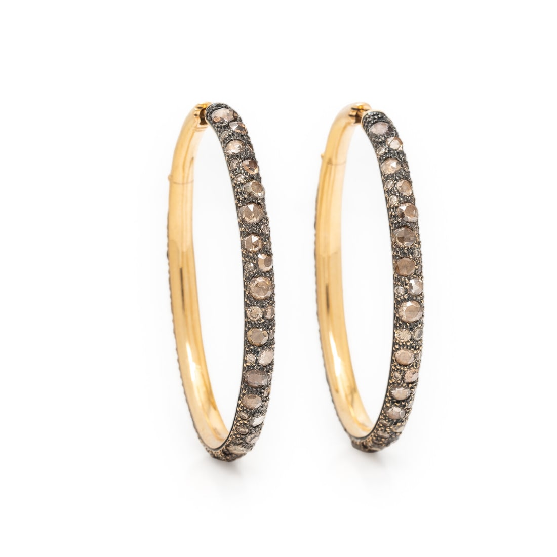 Pomellato, Colored Diamond and Bicolor Gold Oval Hoop Earrings: Pomellato, Colored Diamond and Bicolor Gold Oval Hoop Earrings Set with round brilliant and rose cut yellow, orange, and brown diamonds (origin of color not tested). Mounted in 18 karat yellow and bla