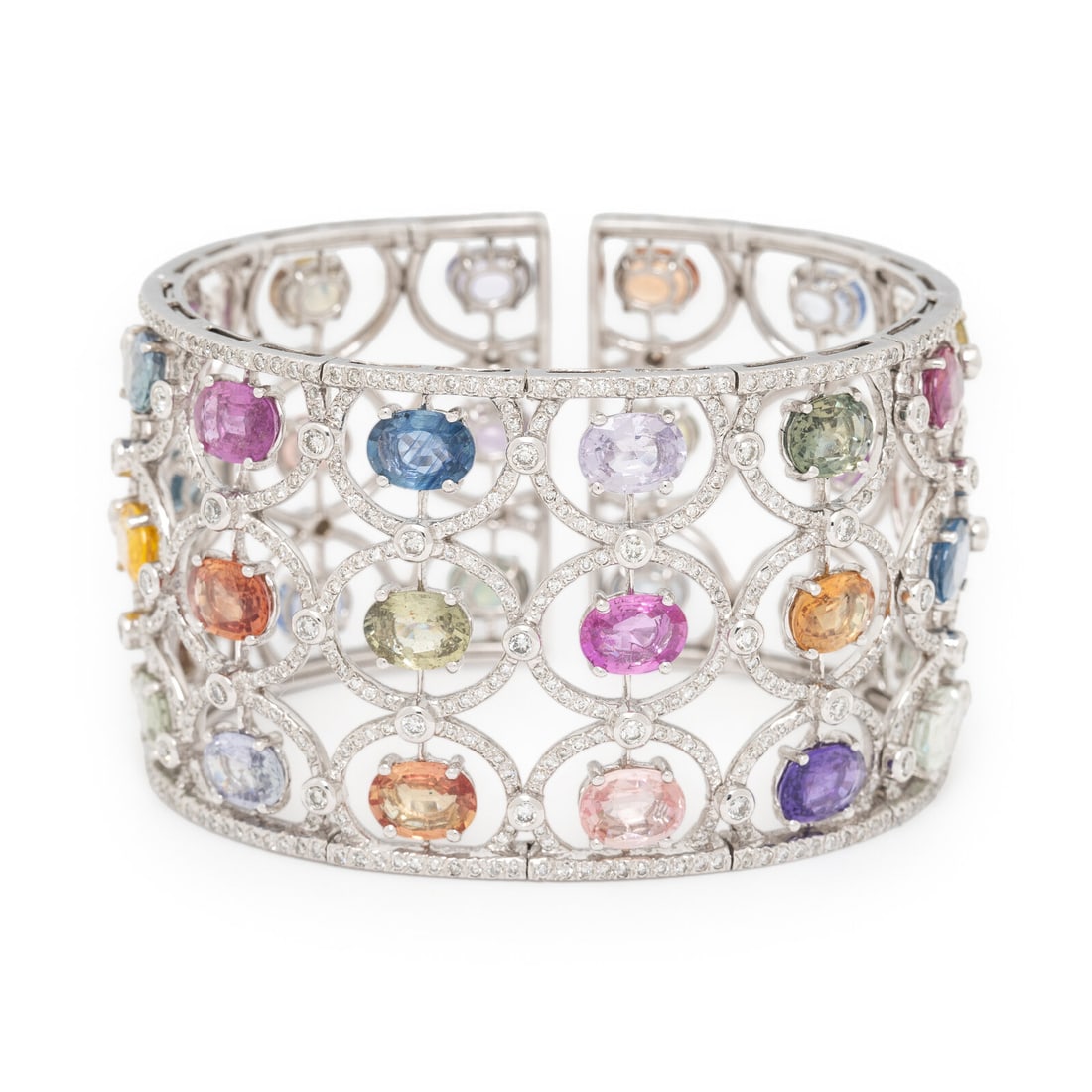 Multi Color Sapphire and Diamond Cuff Bracelet: Multi Color Sapphire and Diamond Cuff Bracelet Designed with variously colored oval sapphires, graduating in size, with round brilliant cut diamond surround weighing approximately 8.05 carats total. M
