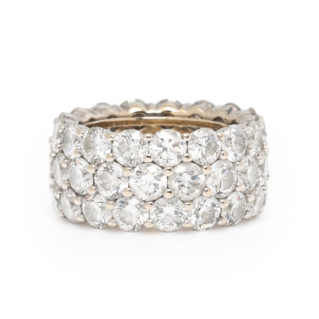 Three Row Diamond Eternity Band: Three Row Diamond Eternity Band Designed with three rows of round brilliant cut diamonds weighing approximately 11.90 carats total. Mounted in 18 karat white gold. Ring size 5 3/4. Stamp: 18K. Gross w