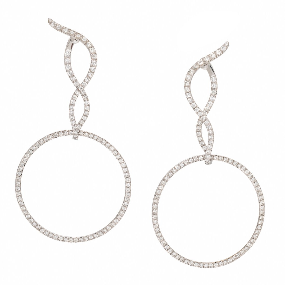 Convertible Diamond Earrings: Convertible Diamond Earrings In a twisted design with detachable hoops, set throughout with round brilliant cut diamonds weighing approximately 8.30 carats total. With hoops: 3 7/8 inches long. Withou