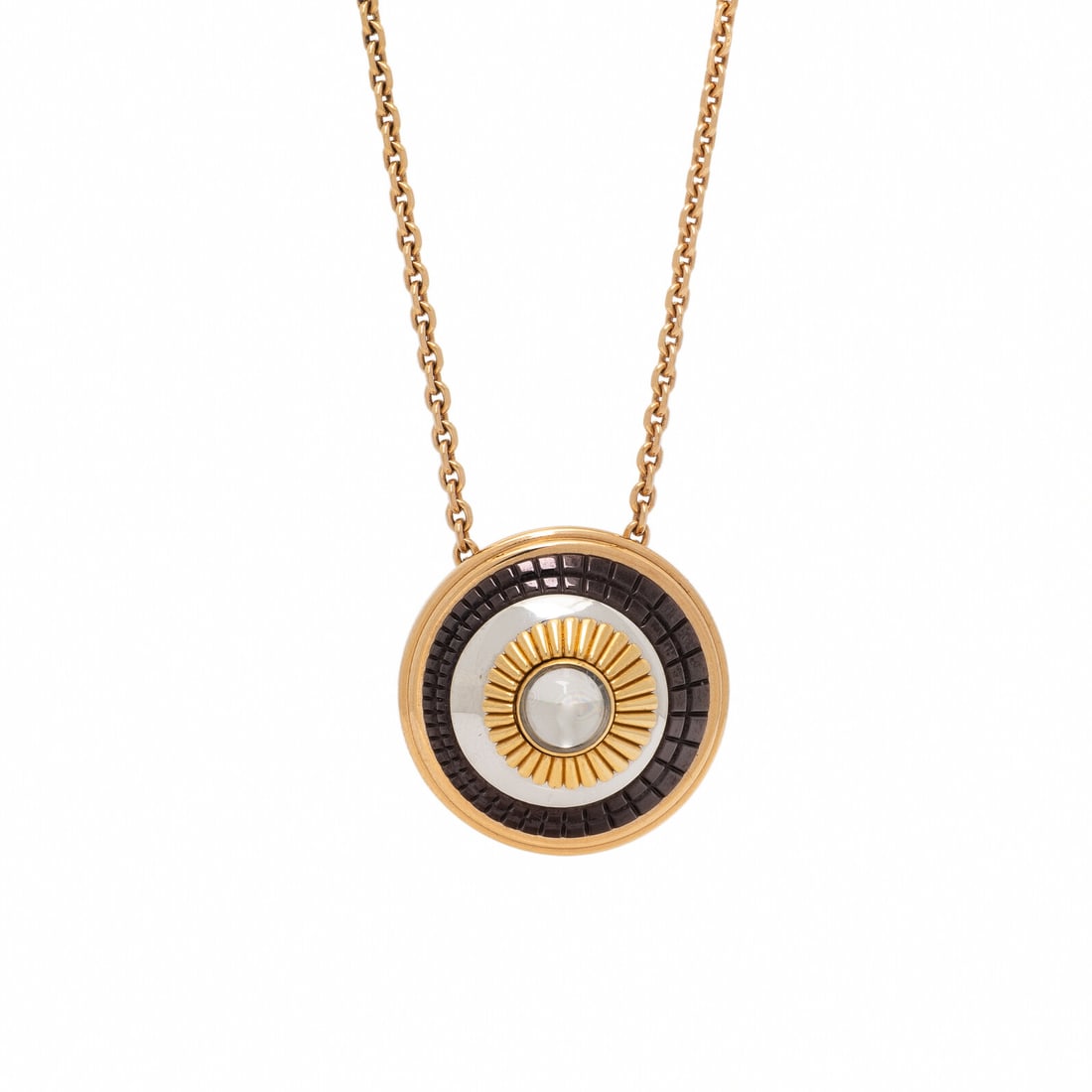 Boucheron, Tricolor Gold and Rock Crystal 'Quatre' Necklace: Boucheron, Tricolor Gold and Rock Crystal 'Quatre' Necklace Featuring a round cabochon rock crystal, surrounded by yellow, white gold, and brown PVD. Mounted in 18 karat rose, white, and yellow gold. 
