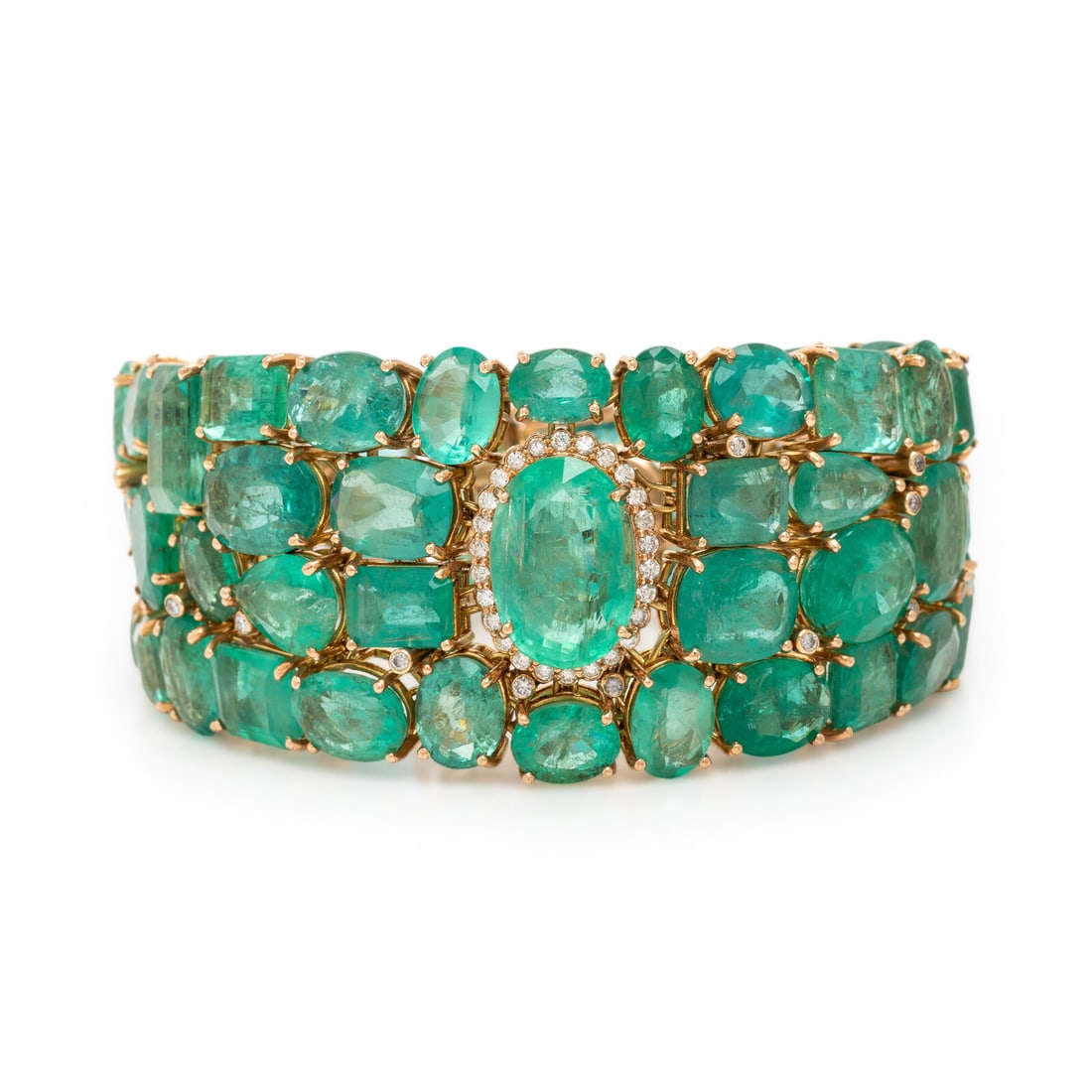 Emerald, Diamond, and Yellow Gold Bracelet: Emerald, Diamond, and Yellow Gold Bracelet With tapered openwork construction, set throughout with variously cut emeralds weighing approximately 108.00 carats total, including the central oval emerald