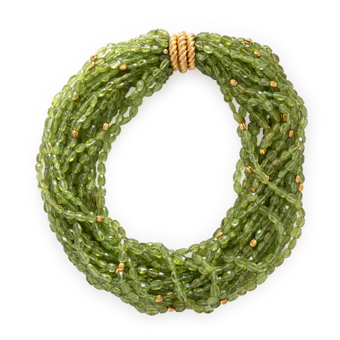 Verdura, Peridot and Yellow Gold Torsade Necklace: Verdura, Peridot and Yellow Gold Torsade Necklace A torsade of numerous strands of oval faceted peridot beads measuring approximately 5.40 - 8.00 mm, punctuated by fluted yellow gold beads. Mounted in
