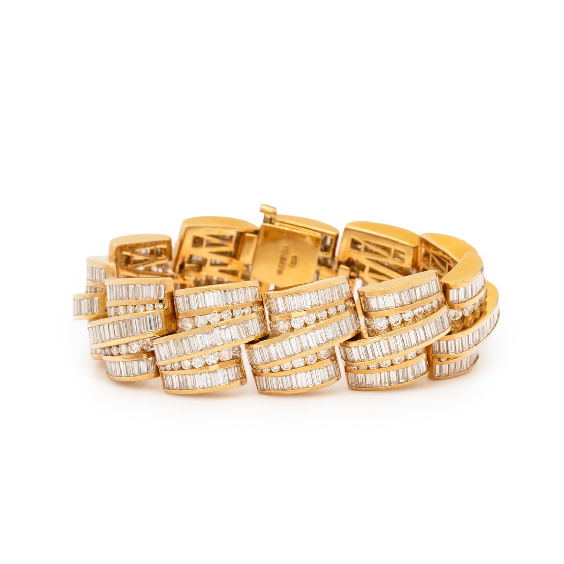 Charles Krypell, Diamond and Yellow Gold Bracelet: Charles Krypell, Diamond and Yellow Gold Bracelet In sculptural links, set with alternating rows of round brilliant and baguette cut diamonds weighing approximately 20.00 - 21.00 carats total. Mounted