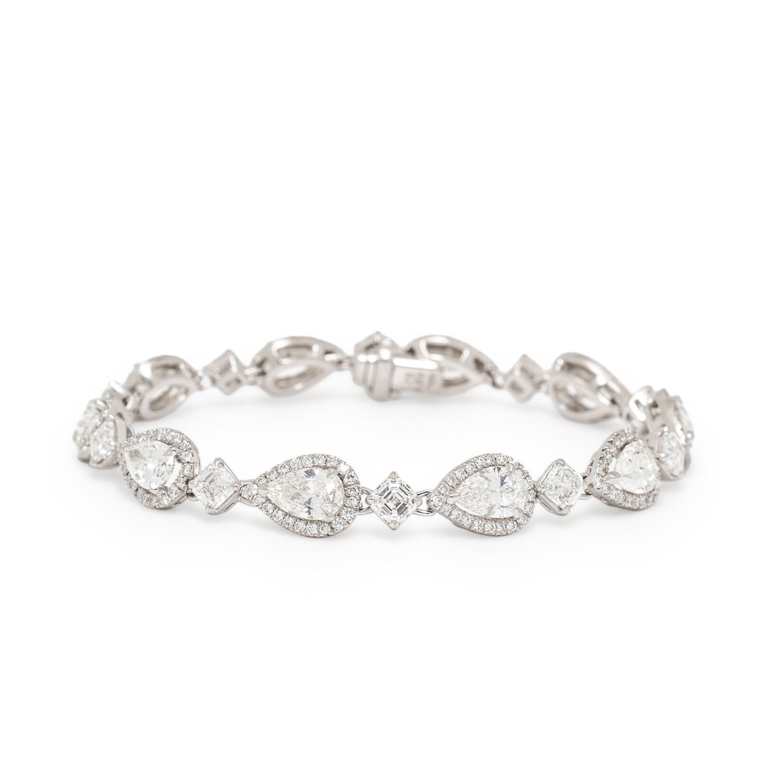 Diamond and Platinum Bracelet: Diamond and Platinum Bracelet Featuring pear shape, Asscher, and round brilliant cut diamonds weighing approximately 10.04 carats total. Mounted in platinum. 6 1/2 inches long. Stamp: 1.15 8.89 PT950.