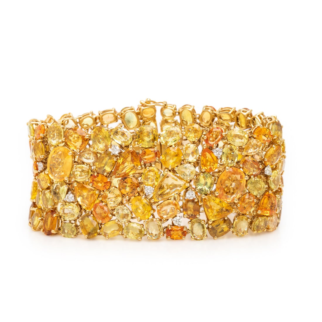 Yellow and Orange Sapphire, Diamond, and Yellow Gold Bracelet: Yellow and Orange Sapphire, Diamond, and Yellow Gold Bracelet Of flexible openwork design, set throughout with an array of variously cut yellow and orange sapphires, and round brilliant cut diamonds w
