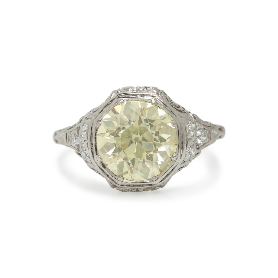 Yellow Diamond, Diamond, and Platinum Ring: Yellow Diamond, Diamond, and Platinum Ring Featuring an old European cut Fancy Light Yellow diamond weighing 2.30 carats, in a scrollwork and openwork design accented by transitional cut diamonds. Mou
