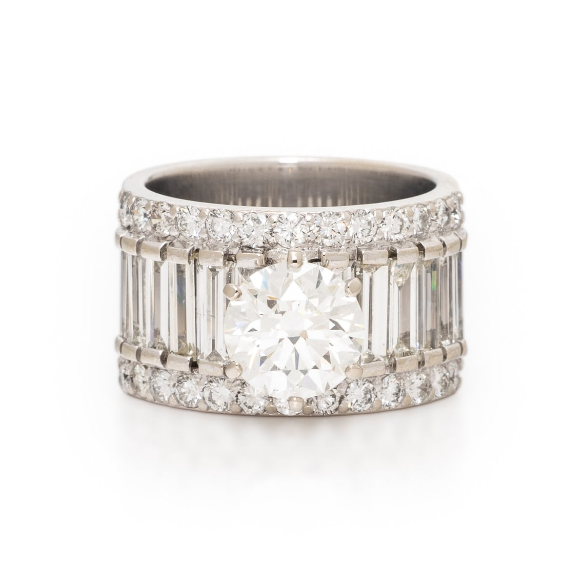 Diamond and White Gold Ring: Diamond and White Gold Ring Featuring a round brilliant cut diamond weighing 1.79 carats, accented by rows of round brilliant and baguette cut diamonds weighing approximately 2.20 carats total. Mounte