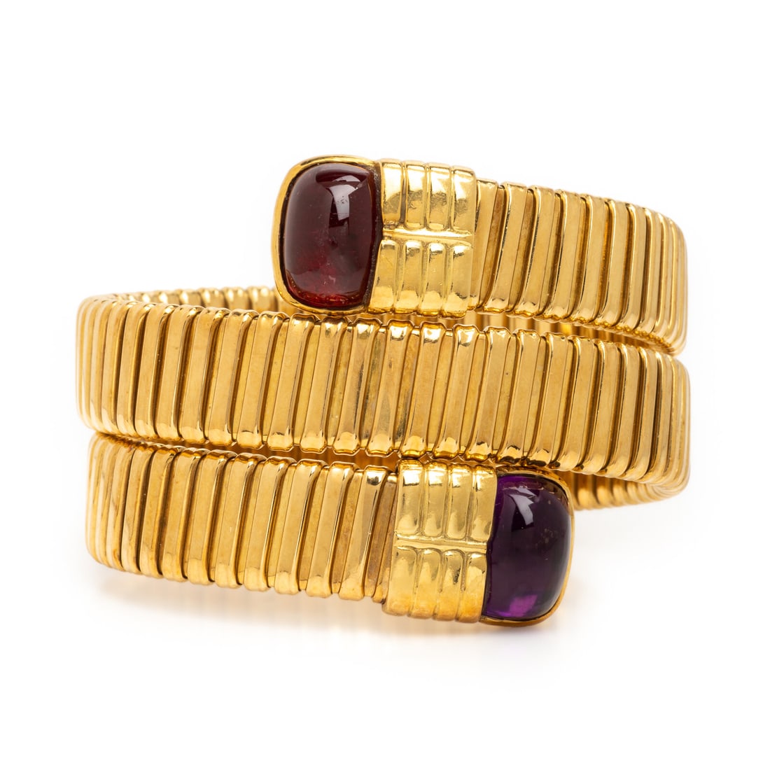Amethyst, Garnet, and Yellow Gold Tubogas Bracelet: Amethyst, Garnet, and Yellow Gold Tubogas Bracelet In a coiled tubogas design, with cushion cut cabochon amethyst and garnet each measuring approximately 14.00 x 10.50 mm. Mounted in yellow gold. 5 3/