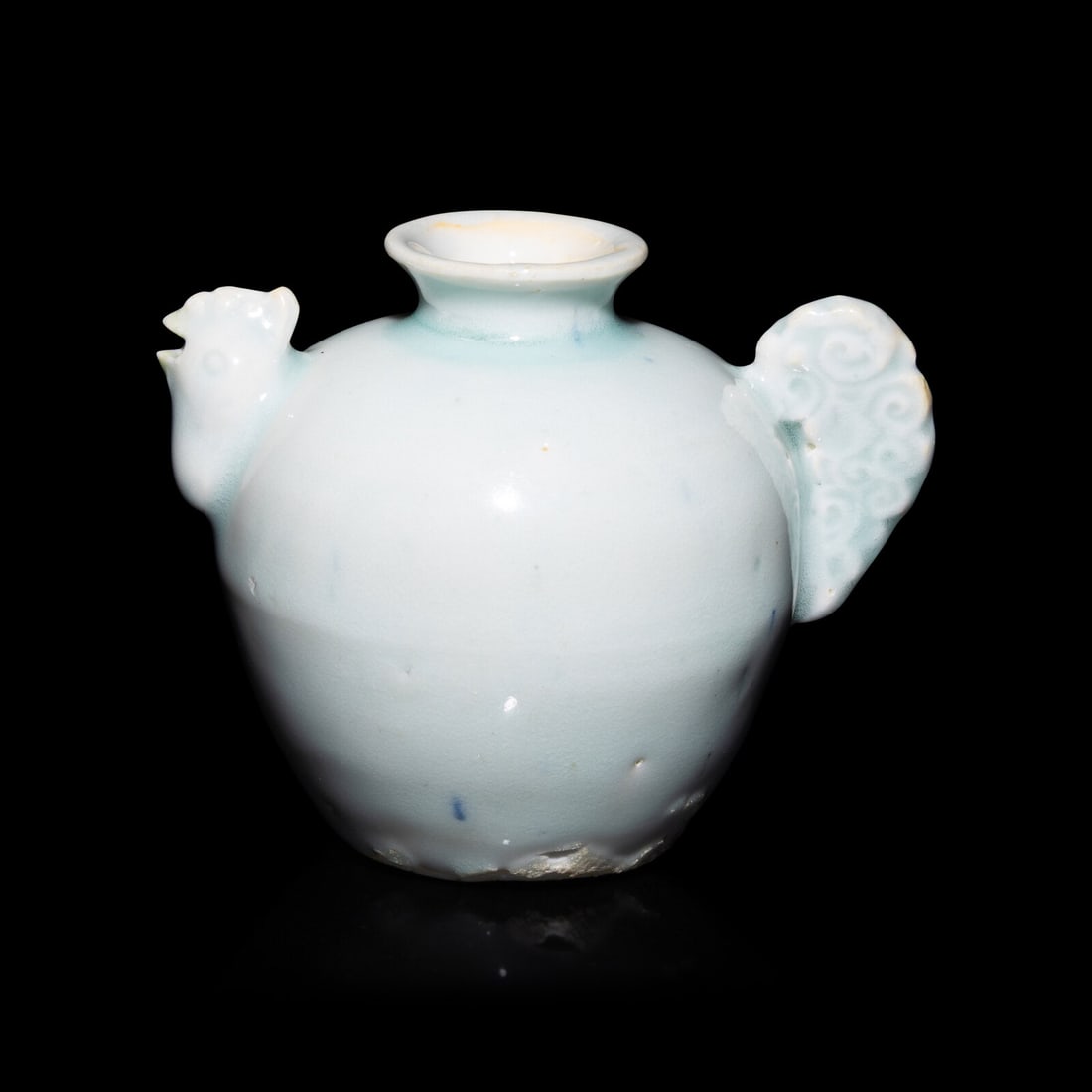 A Chinese Qingbai Glazed Chicken-Head Water Dropper, Yuan Dynasty: A Chinese Qingbai Glazed Chicken-Head Water Dropper, Yuan Dynasty 元 影青釉雞首壺 Height 3 9/16 in., 9 cm. This lot is located in Philadelphia. Provenance: Lo