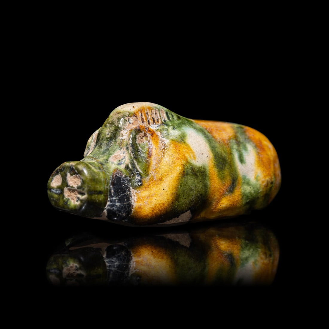 A Small Chinese Sancai Glazed Pottery Boar, Tang Dynasty: A Small Chinese Sancai Glazed Pottery Boar, Tang Dynasty 唐 三彩陶豬 The recumbent boar with long snout, the sturdy body topped by a large bristling mane that runs in a c