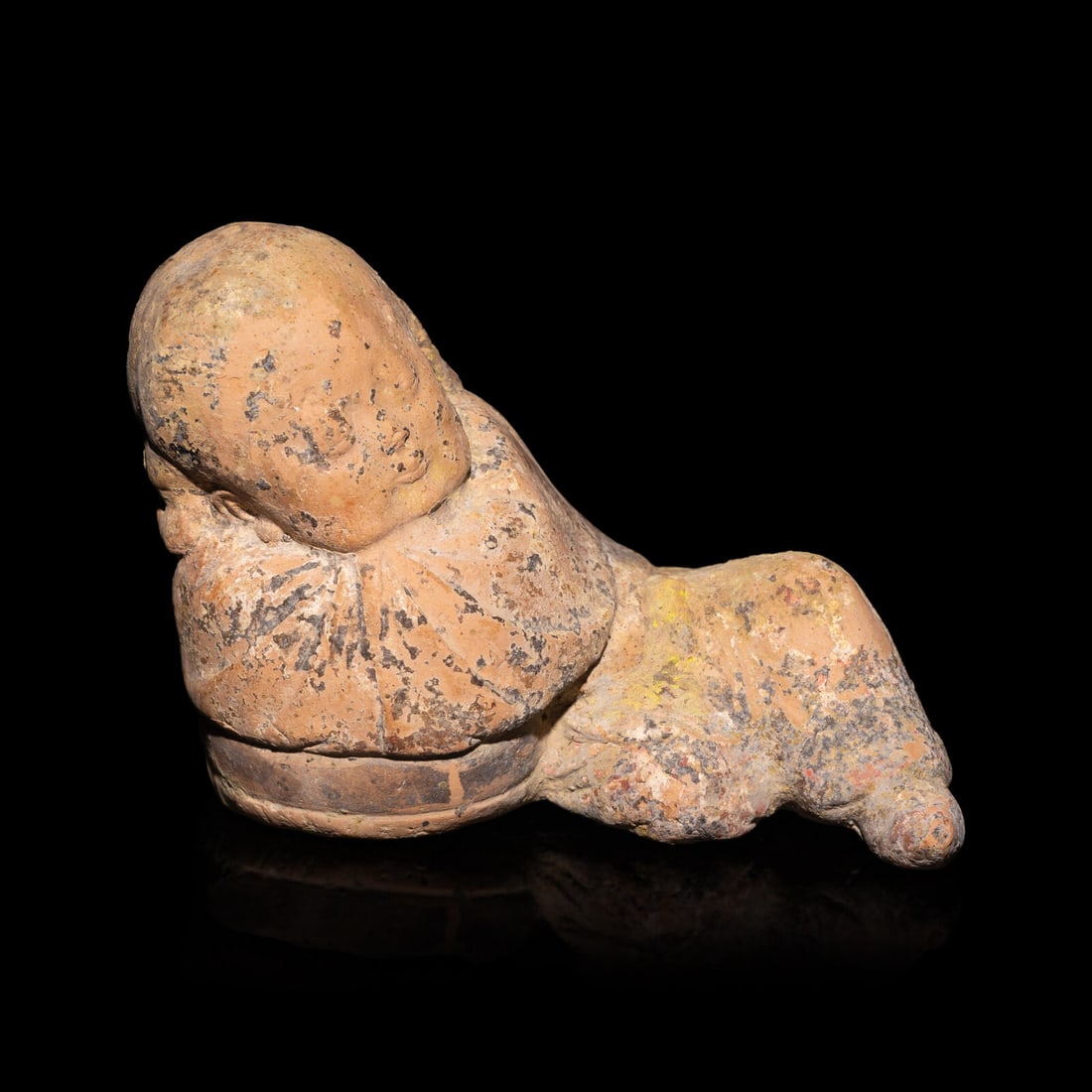 A Chinese Painted Pottery Figure of a Girl, Song Dynasty: A Chinese Painted Pottery Figure of a Girl, Song Dynasty 宋 彩繪陶臥女童 Length 4 1/2 in., 11.5 cm. This lot is located in Philadelphia.