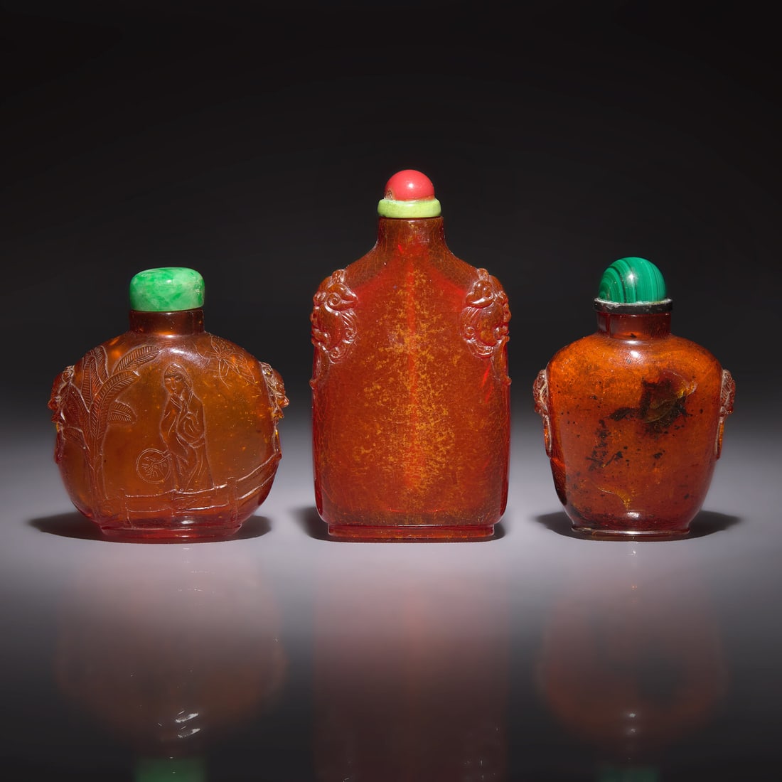 Three Chinese Amber Snuff Bottles, 18th to 19th Century: Three Chinese Amber Snuff Bottles, 18th to 19th Century 清中期 琥珀鼻烟壺三支 -The first, 18th century, of flattened squat rounded form, the