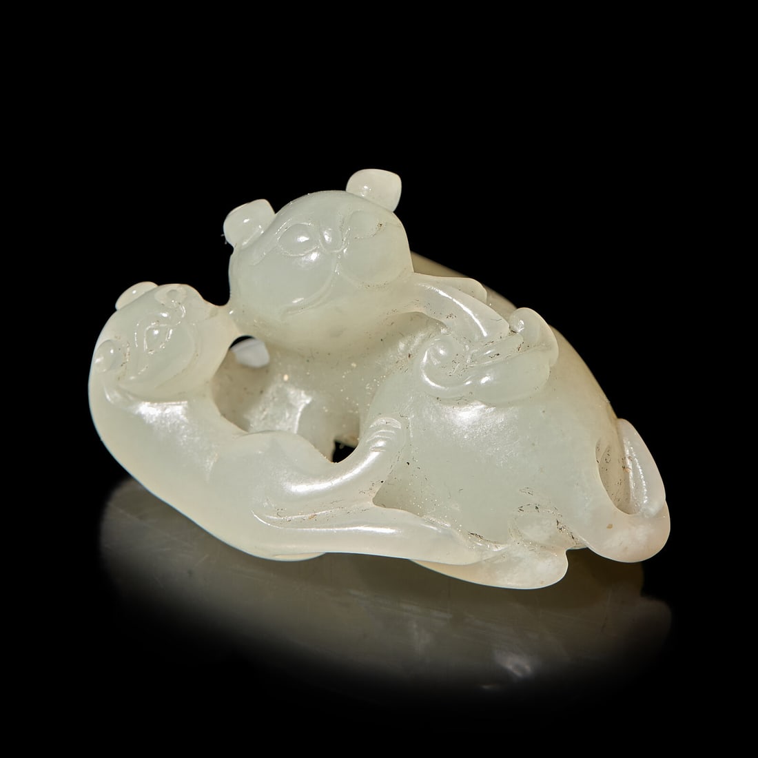 A Chinese Pale Celadon Jade ‘Double Badger' Group, Qing Dynasty: A Chinese Pale Celadon Jade ‘Double Badger' Group, Qing Dynasty 清 青白玉雙歡珮 Depicting a pair of recumbent cats resting together. Length 1 15/16 in.,