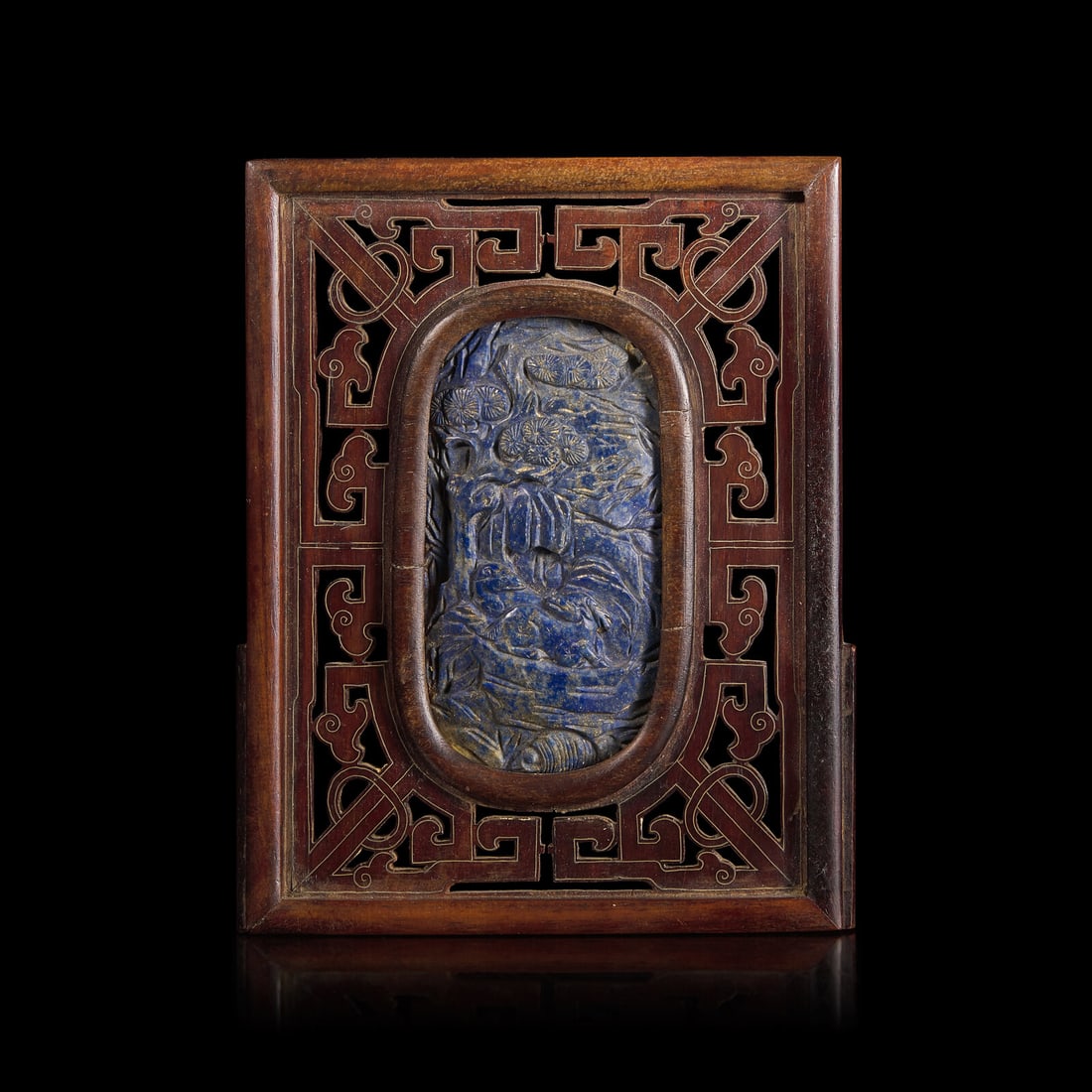 A Chinese Carved Lapis Lazuli Oval "Deer and Pine" Panel, Qing Dynasty: A Chinese Carved Lapis Lazuli Oval "Deer and Pine" Panel, Qing Dynasty 清 硬木嵌青金石“鹿鶴同春”圖牌 Probably 