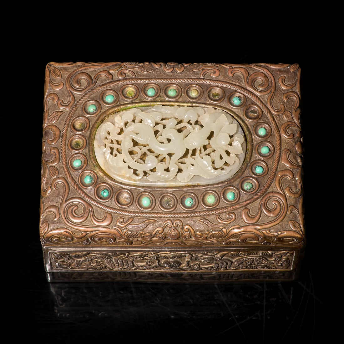 A Chinese Jade and Turquoise Embellished Brass Box: A Chinese Jade and Turquoise Embellished Brass Box 銅嵌玉及綠松石蓋盒 The copper box with low-relief scroll decorations, inlaid with a reticulated