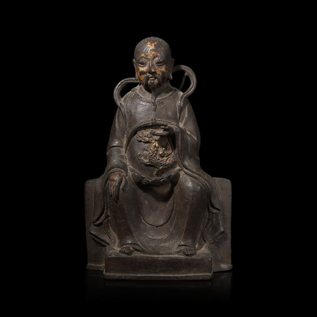 A Chinese Parcel Gilt Bronze Figure of Zhenwu, Ming Dynasty: A Chinese Parcel Gilt Bronze Figure of Zhenwu, Ming Dynasty 明 銅鎏金真武大帝 The seated deity wears a belted robe decorated with dragons Height 10 1/4 