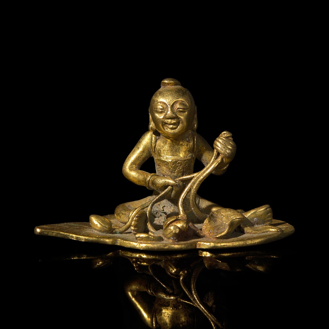 A Small Chinese Bronze Figure of a Boy with Lotus, Qing Dynasty (1 of 3)