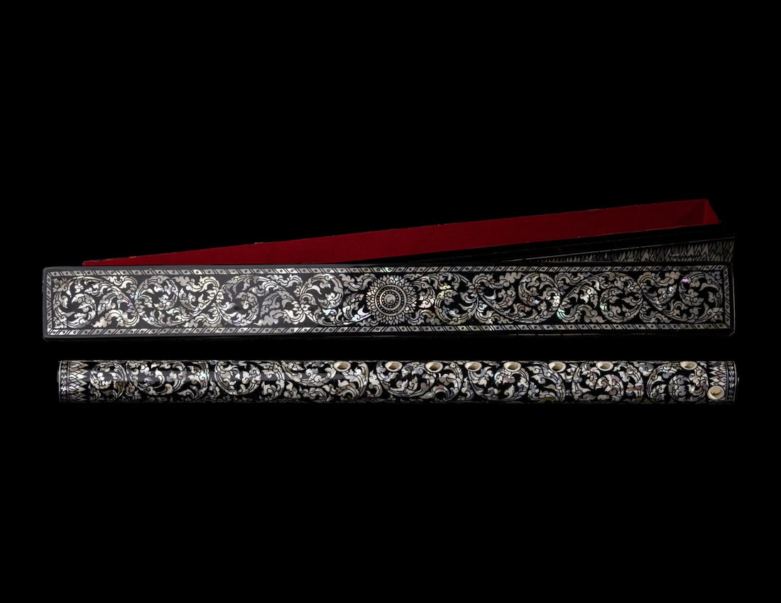 Two Chinese Flutes: Two Chinese Flutes 黑漆螺鈿及窯變釉瓷笛兩支 Comprising a porcelain example, together with a hardwood box; a mother-of-pearl inla
