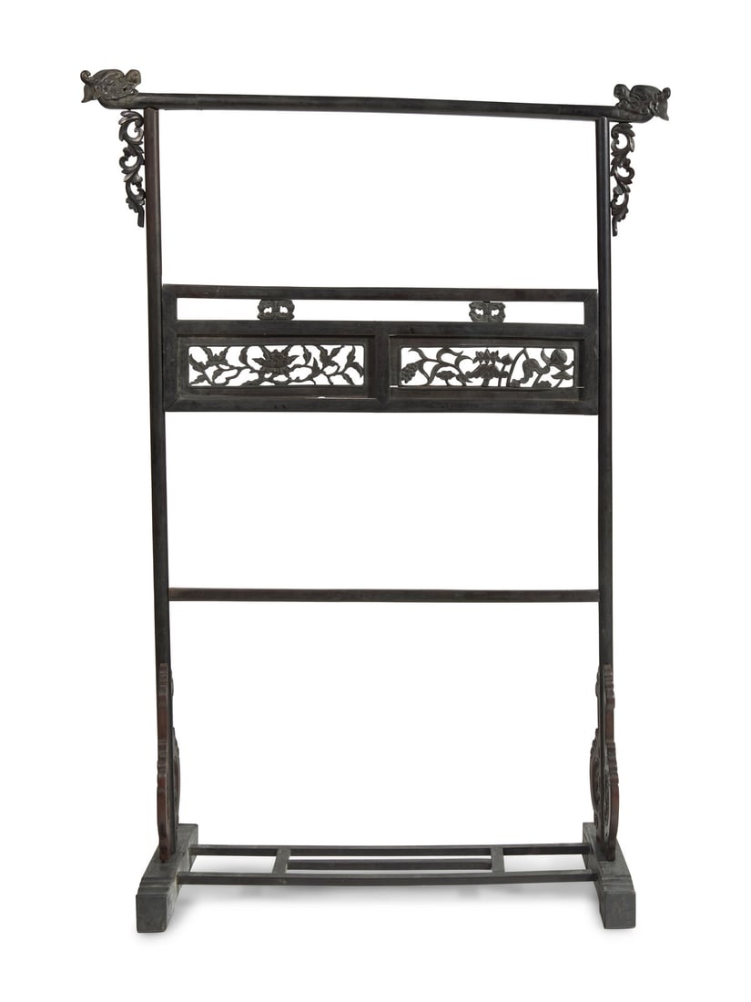 A Chinese Hardwood Clothing Stand, Yijia, Qing Dynasty: A Chinese Hardwood Clothing Stand, Yijia, Qing Dynasty 清 硬木衣架 The circular uprights supporting a crest rail with lion-head finials, over a stretcher carved with peon