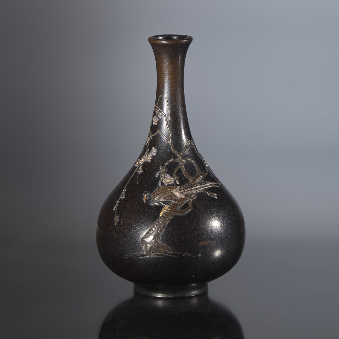 A Finely-Decorated Japanese Mixed Metals Inlaid "Pheasant and Flowers" Patinated Bronze Vase,: A Finely-Decorated Japanese Mixed Metals Inlaid "Pheasant and Flowers" Patinated Bronze Vase, Yamamoto Koken, Meiji Period The vase embellished with a finely-detailed pheasant perched on a flowering p