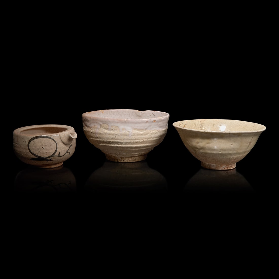 Two Japanese Ceramic Bowls and a Pouring Vessel, 19th Century and Earlier: Two Japanese Ceramic Bowls and a Pouring Vessel, 19th Century and Earlier The first bowl flared, of buff paste with cream and beige crackled glaze, four large spur marks to the interior, kintsugi repa