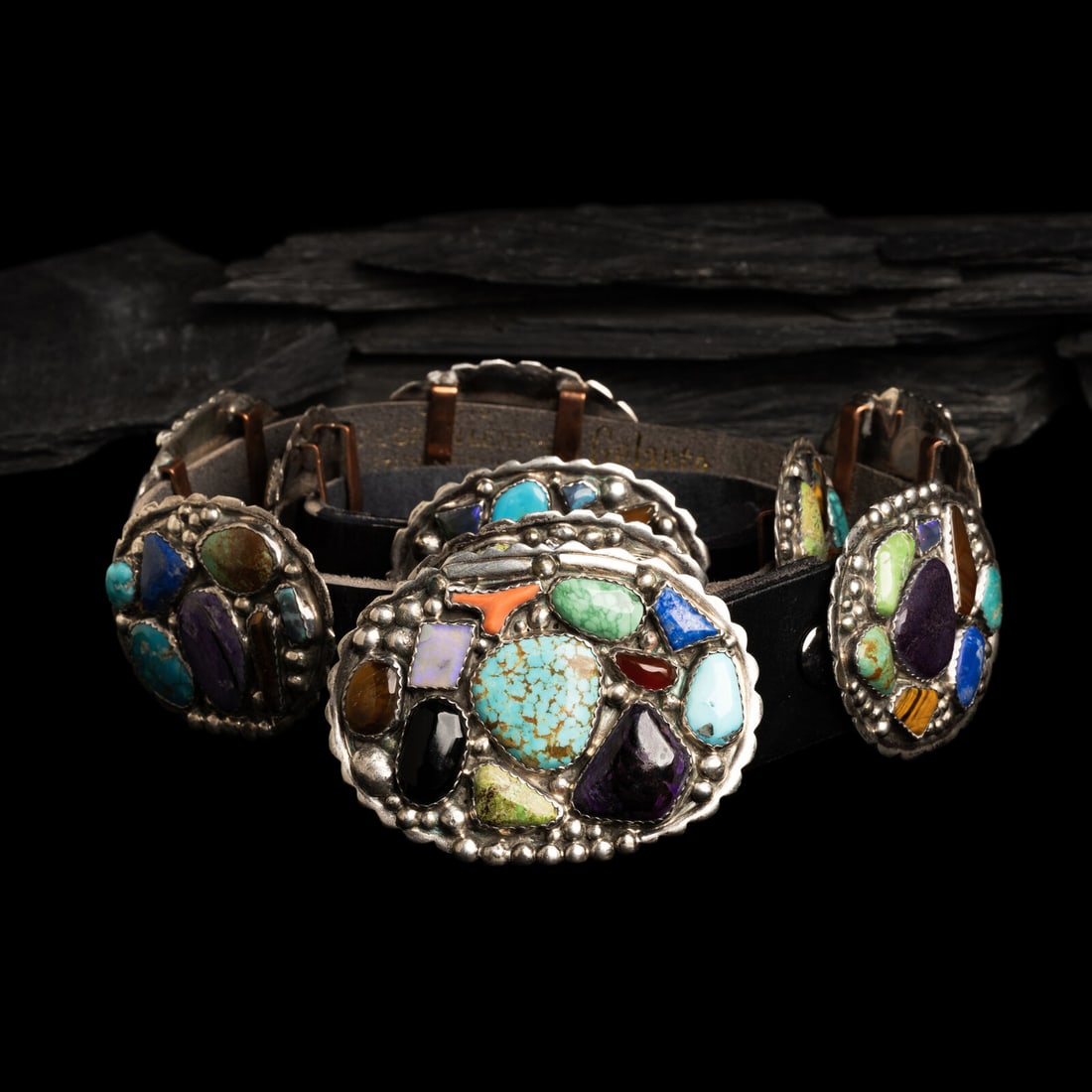 Southwestern Sterling Silver and Multi-stone Concha Belt: Southwestern Sterling Silver and Multi-stone Concha Belt second half 20th century nine oval conchas and matching buckle, each set with an assortment cluster of stones including turquoise, lapis,