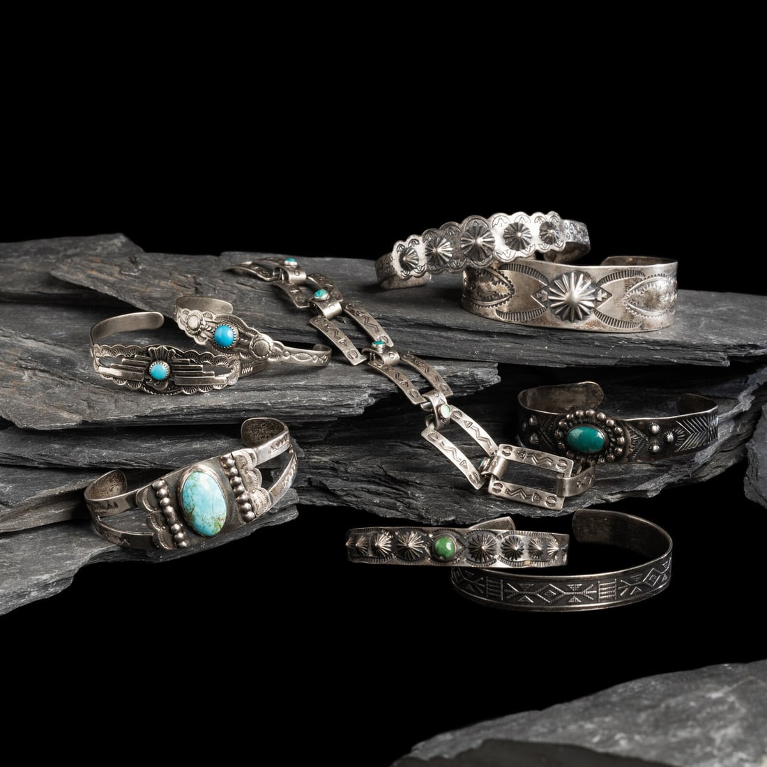 Navajo Curio Bracelets: Navajo Curio Bracelets first half 20th century lot of 9, includes: one link bracelet set with turquoise and marked STERLING on back of clasp length 6-7/8 inches x width 5/8 inch weight 11.7 dwt. one