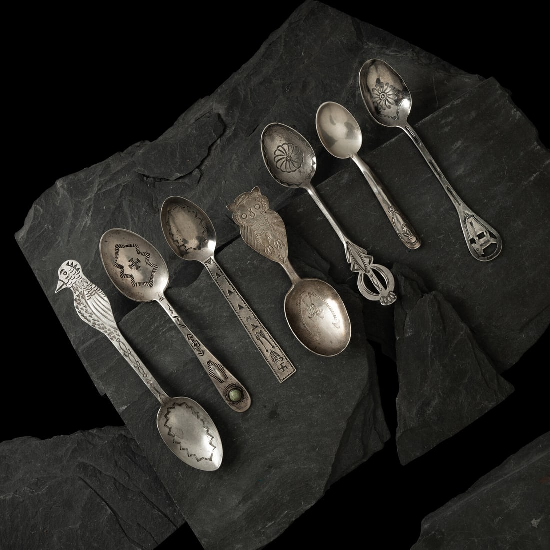 Navajo Silver Curio Spoons: Navajo Silver Curio Spoons first half 20th century lot of 7, includes: the smallest, with lightly stamped design on handle; marked UITA2 for CG Wallace length 3-3/4 inches weight 5.2 dwt. one with a
