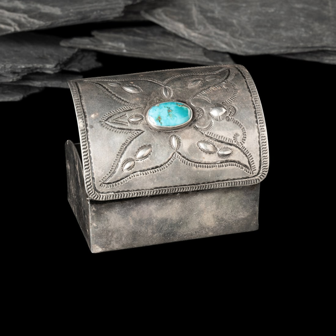 Navajo Silver and Turquoise Lidded Box: Navajo Silver and Turquoise Lidded Box second quarter 20th century with a ketoh-style lid, heavily stamped butterfly design centered around a single Blue Gem Turquoise cabochon; not marked height 2-1/