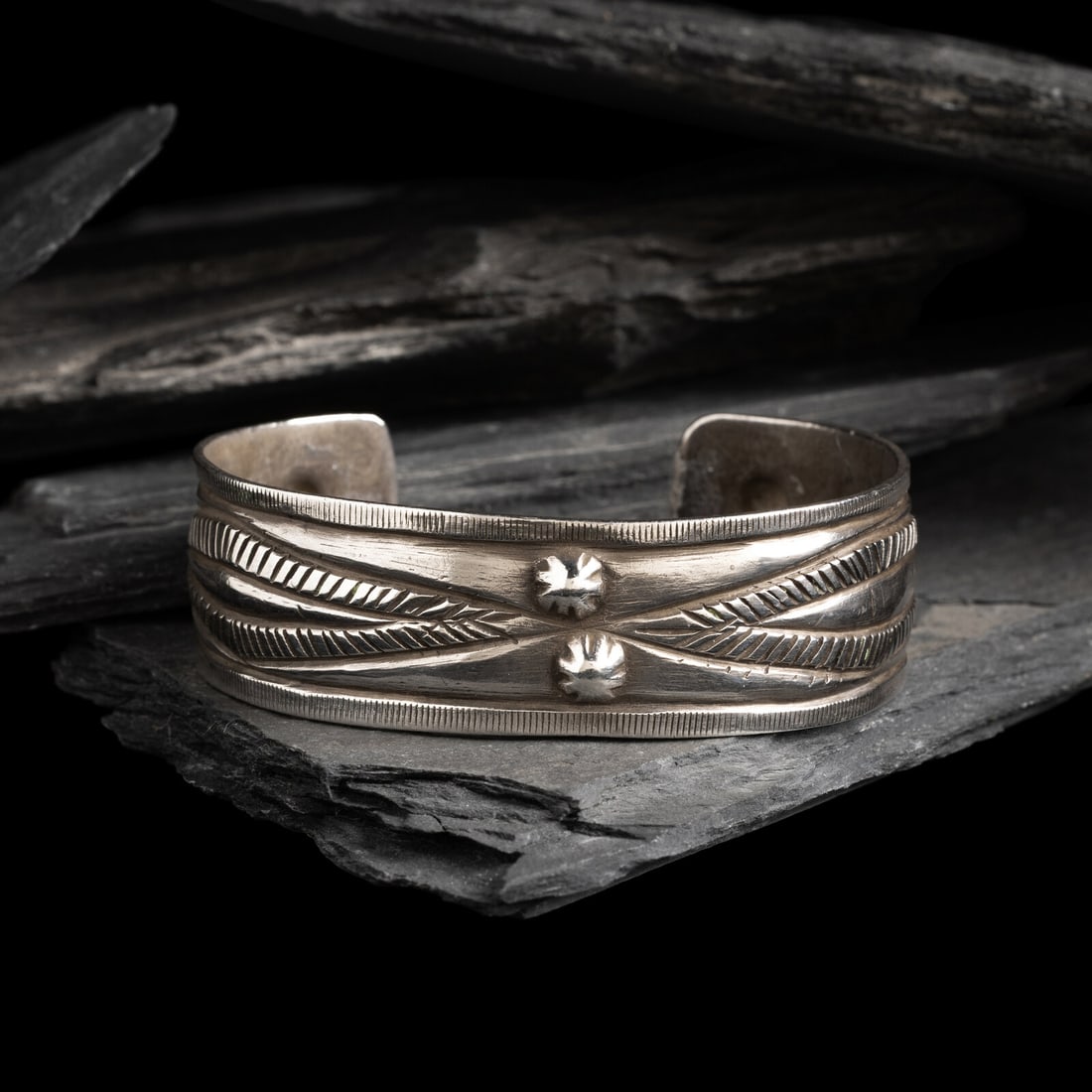 Early Navajo Chiseled Cuff Bracelet, with RepoussÈ Elements: Early Navajo Chiseled Cuff Bracelet, with RepoussÈ Elements ca 1890 finely chiseled design with two lightly repoussÈd offset diamonds and four smaller bump outs; not marked width 3/4 inch in