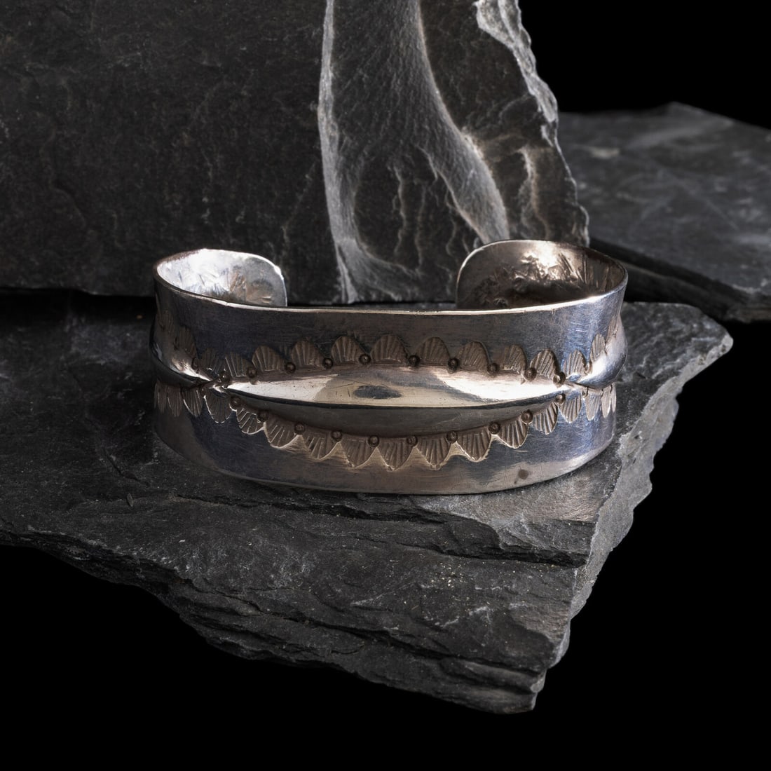 Early Navajo Ingot Cuff Bracelet: Early Navajo Ingot Cuff Bracelet ca 1890 with a row of three repoussÈ diamonds accented with stamping; not marked width 1 inch interior circumference 5-1/2 inches + gap length 7/8 inch weight 20.