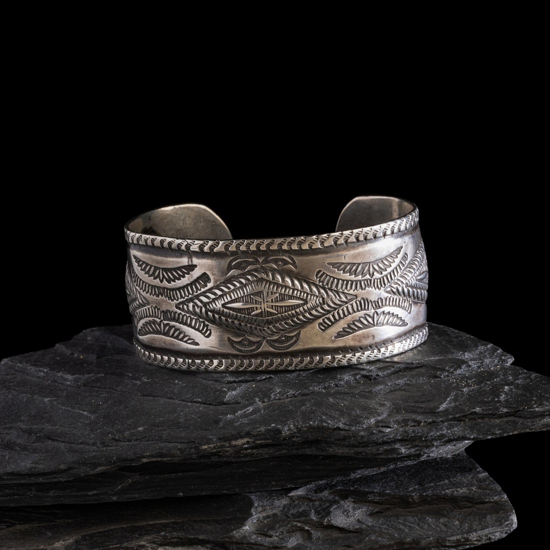 Early Navajo Heavily Stamped Ingot Cuff Bracelet: Early Navajo Heavily Stamped Ingot Cuff Bracelet ca 1890-1900 three lightly repoussÈd diamonds accented with heavy stamping; not marked width 1-1/8 inches interior circumference 5-7/8 inches + ga