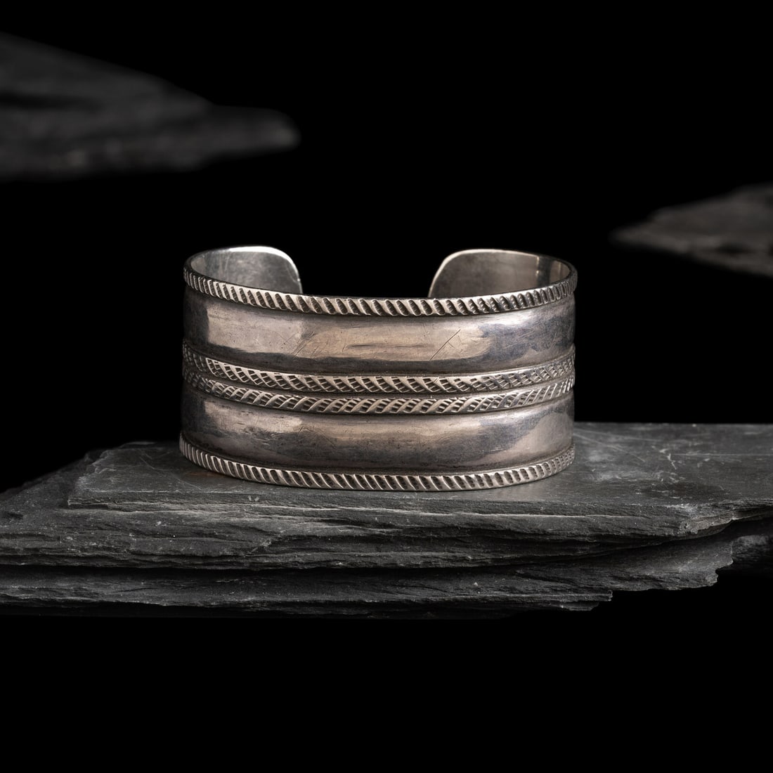 Early Navajo Stamped and Chiseled Ingot Cuff Bracelet: Early Navajo Stamped and Chiseled Ingot Cuff Bracelet ca 1890-1910 elegantly simple banded design, alternating with chiseled and stamped elements not marked width 1-1/8 inches interior circumference 5