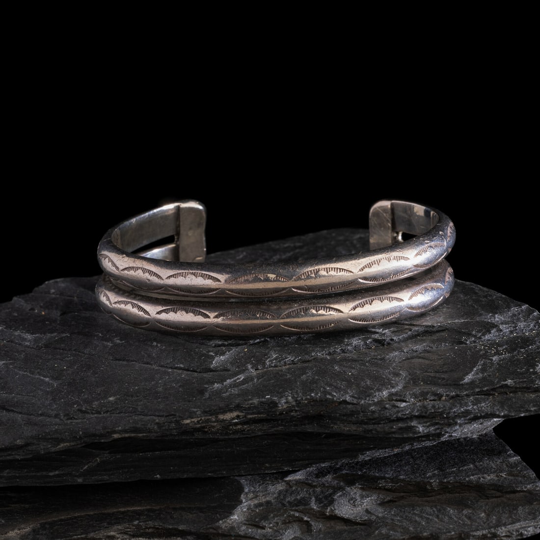 Navajo Stamped Double Bangle Ingot Cuff Bracelet: Navajo Stamped Double Bangle Ingot Cuff Bracelet ca 1910 not marked width 1/2 inch interior circumference 5-5/8 inches + gap length 1-1/4 inches weight 33.0 dwt. This lot is located in Chicago. Proven