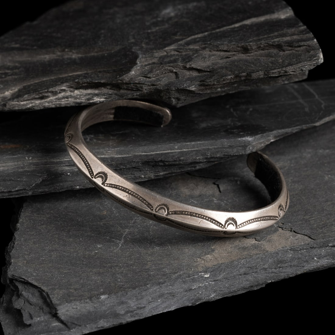 Navajo Stamped Carinated Ingot Cuff Bracelet: Navajo Stamped Carinated Ingot Cuff Bracelet ca 1900-1920 not marked width 3/8 inch interior circumference 5-3/4 inches + gap length 1 inch weight 22.5 dwt. This lot is located in Chicago.