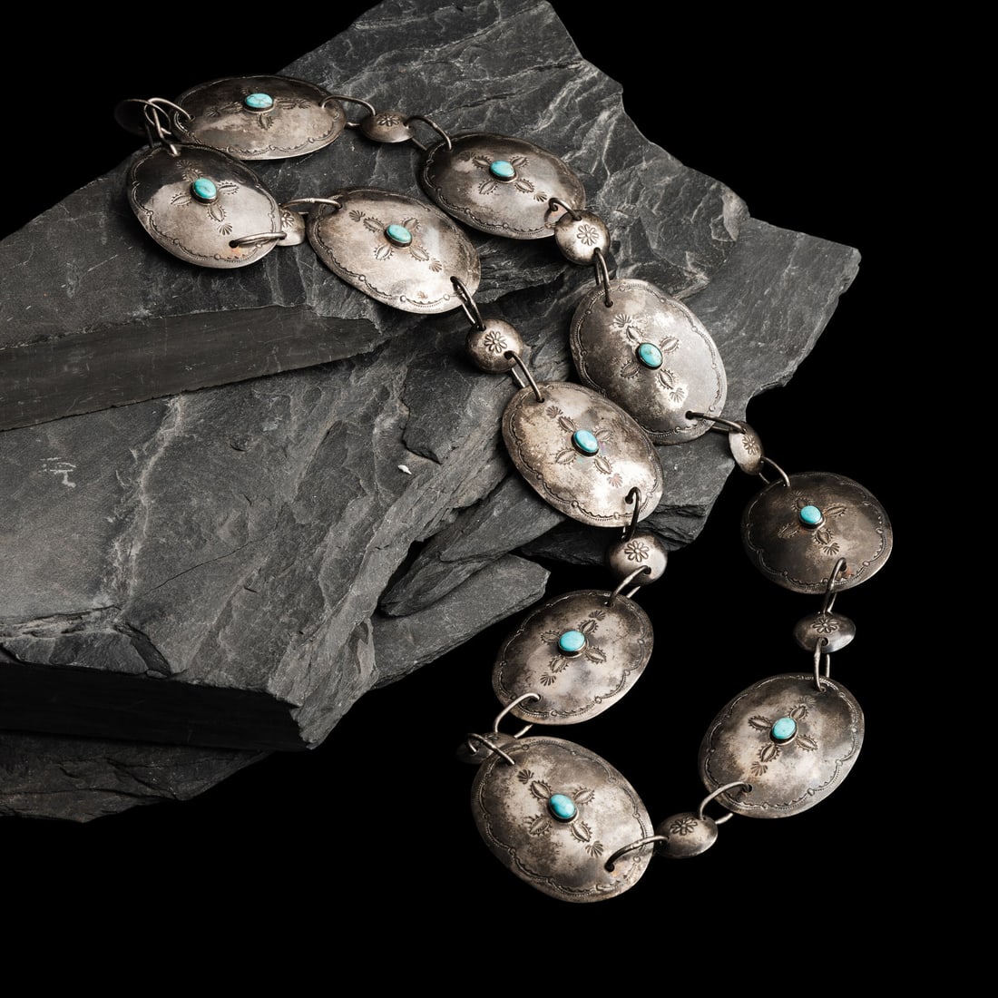 Garden of the Gods Trading Post (Shop, act. since 1929) Navajo Silver and Turquoise Link Concha: Garden of the Gods Trading Post (Shop, act. since 1929) Navajo Silver and Turquoise Link Concha Belt, ca 1940s ten stamped conchas each set with a single stone alternate with a smaller link; marked