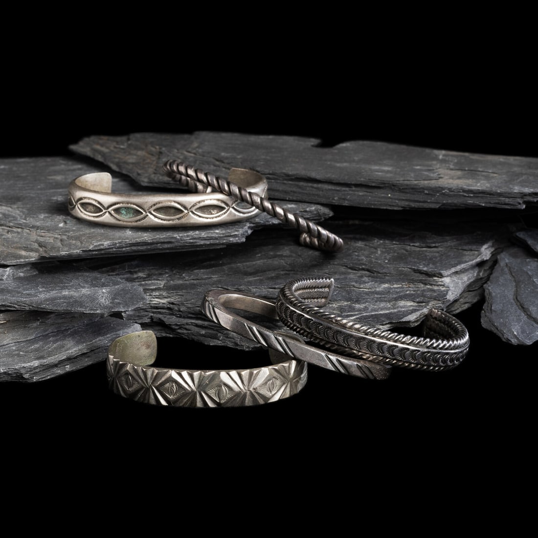 Navajo Silver Cuff Braclets: Navajo Silver Cuff Braclets first half 20th century lot of 5, none are marked, includes: one example with a pair of twisted wires house a central stamped band width 1/2 inch interior circumference 5-1