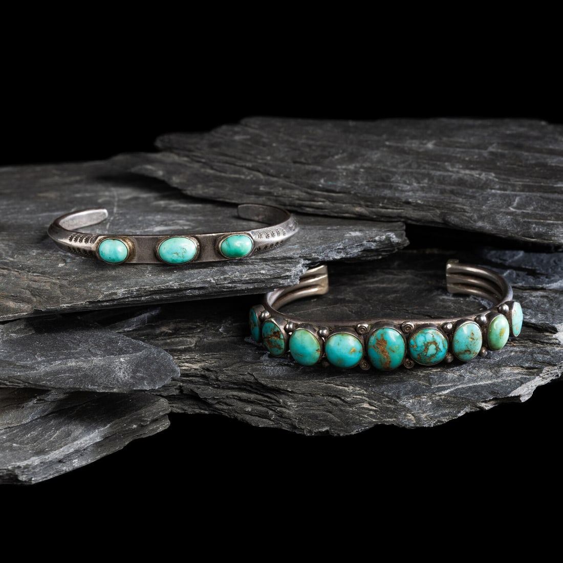 Pair of Navajo Silver and Turquoise Cuff Braclets: Pair of Navajo Silver and Turquoise Cuff Braclets second quarter 20th century lot of 2, neither are marked, includes: a carinated example with stamped shank and set with three stones width 5/16 inch i