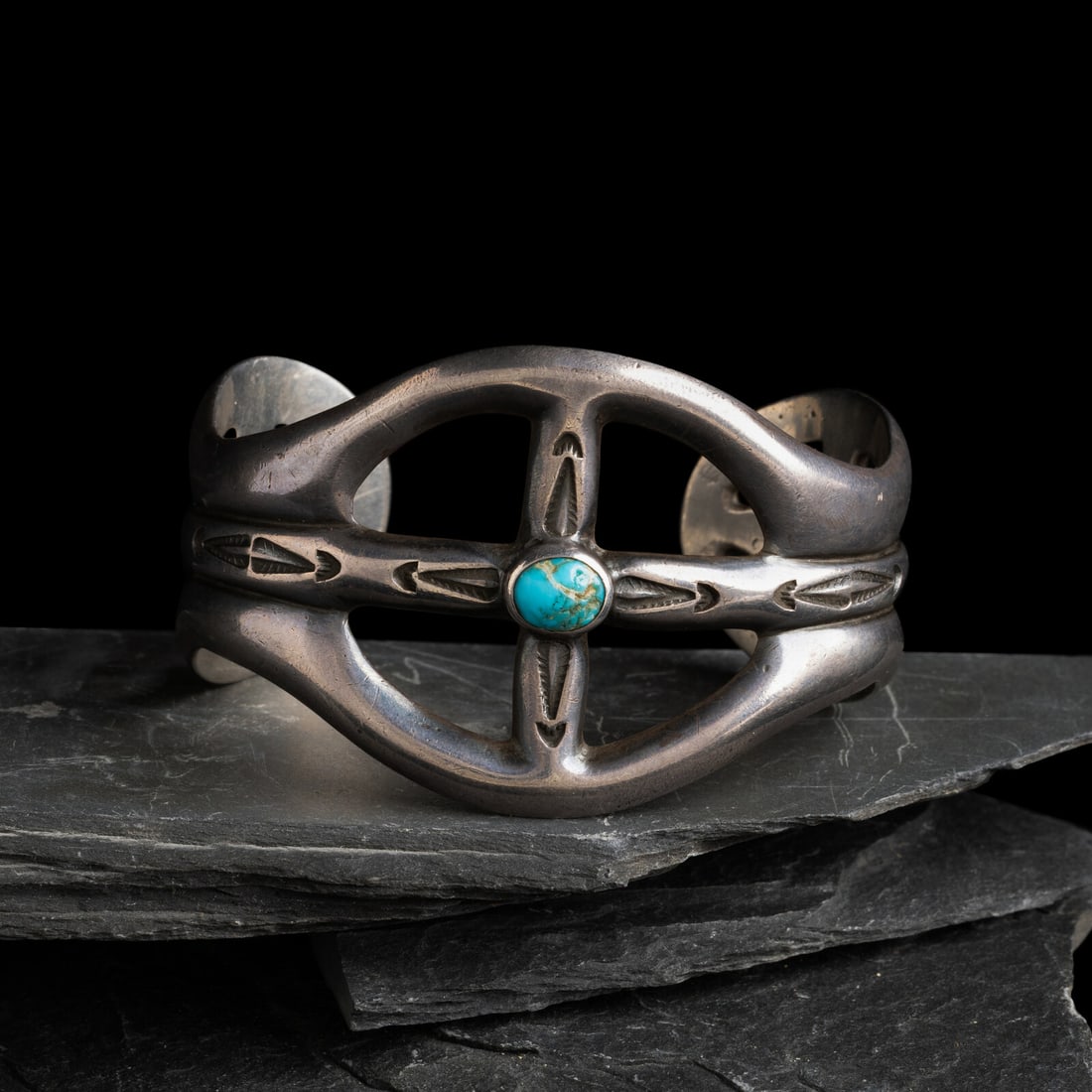 Navajo Sand Cast Silver and Turquoise Cuff Bracelet, US NAVAJO 40: Navajo Sand Cast Silver and Turquoise Cuff Bracelet, US NAVAJO 40 second quarter 20th century marked US NAVAJO 40 for the Fort Wingate Indian School, New Mexico width 1-5/8 inches interior circumferen