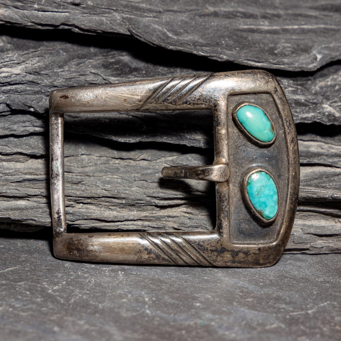 The White Hogan Silver Shop (Shop, 1946-2006) Sterling Silver and Turquoise Belt Buckle: The White Hogan Silver Shop (Shop, 1946-2006) Sterling Silver and Turquoise Belt Buckle marked STERLING with the hogan hallmark height 1-5/8 inches x length 2 inches belt width 15/16 inch weight 14.4