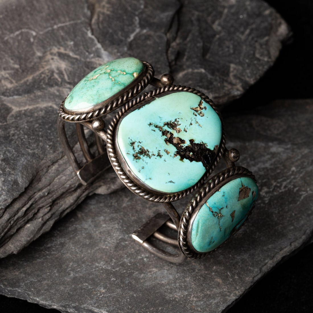 Navajo Silver and Turquoise Cuff Bracelet: Navajo Silver and Turquoise Cuff Bracelet second quarter - mid 20th century wire cuff set with three stones in a twisted wire bezel; not marked width 1-5/8 inches interior circumference 5-3/8 inches