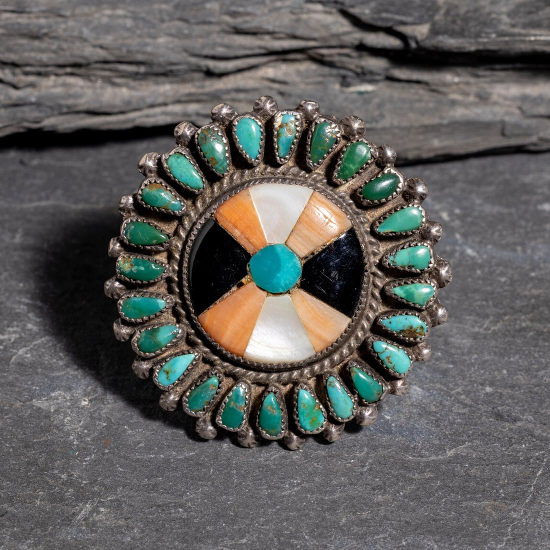 Zuni Mosaic Inlay Ring: Zuni Mosaic Inlay Ring ca 1940s split shank ring, set with turquoise, spiny oyster, shell, and jet; not marked size 8 weight 5.1 dwt. This lot is located in Chicago.