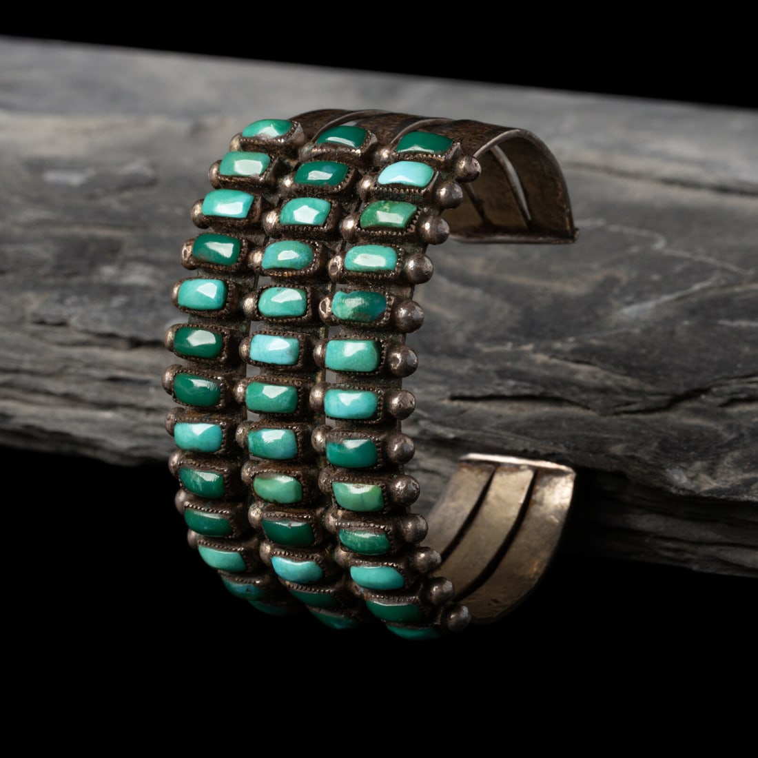 Navajo or Zuni Silver and Turquoise Cluster Cuff Bracelet: Navajo or Zuni Silver and Turquoise Cluster Cuff Bracelet mid-20th century etched on the back E.A width 1-3/8 inches interior circumference 5-3/8 inches + gap length 1 inch weight 38.0 dwt. This lot